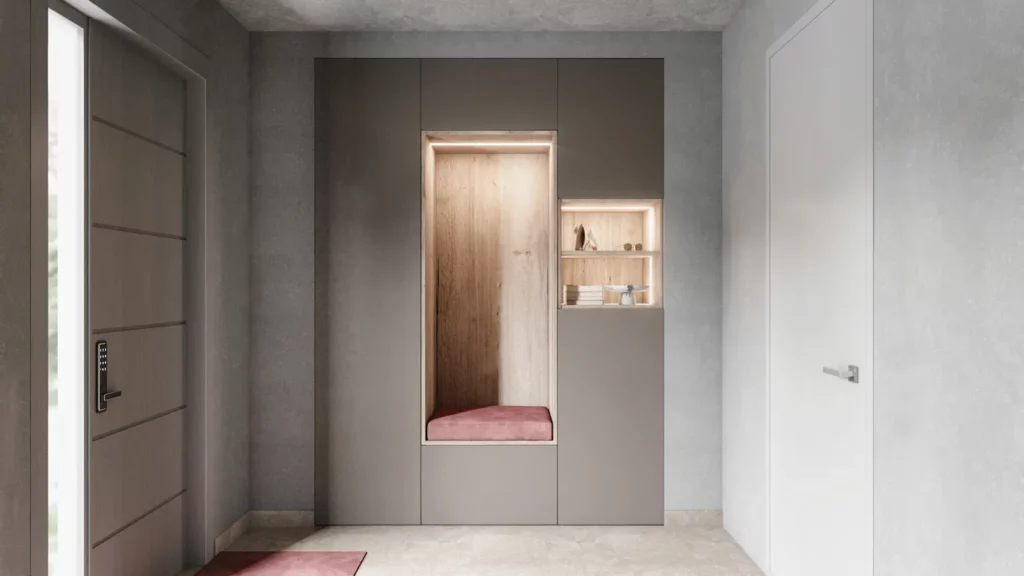 Vestiaire d'entrée minimaliste : Niche de rangement encastrée dans un mur gris avec assise rouge, idéale pour les couloirs étroits.