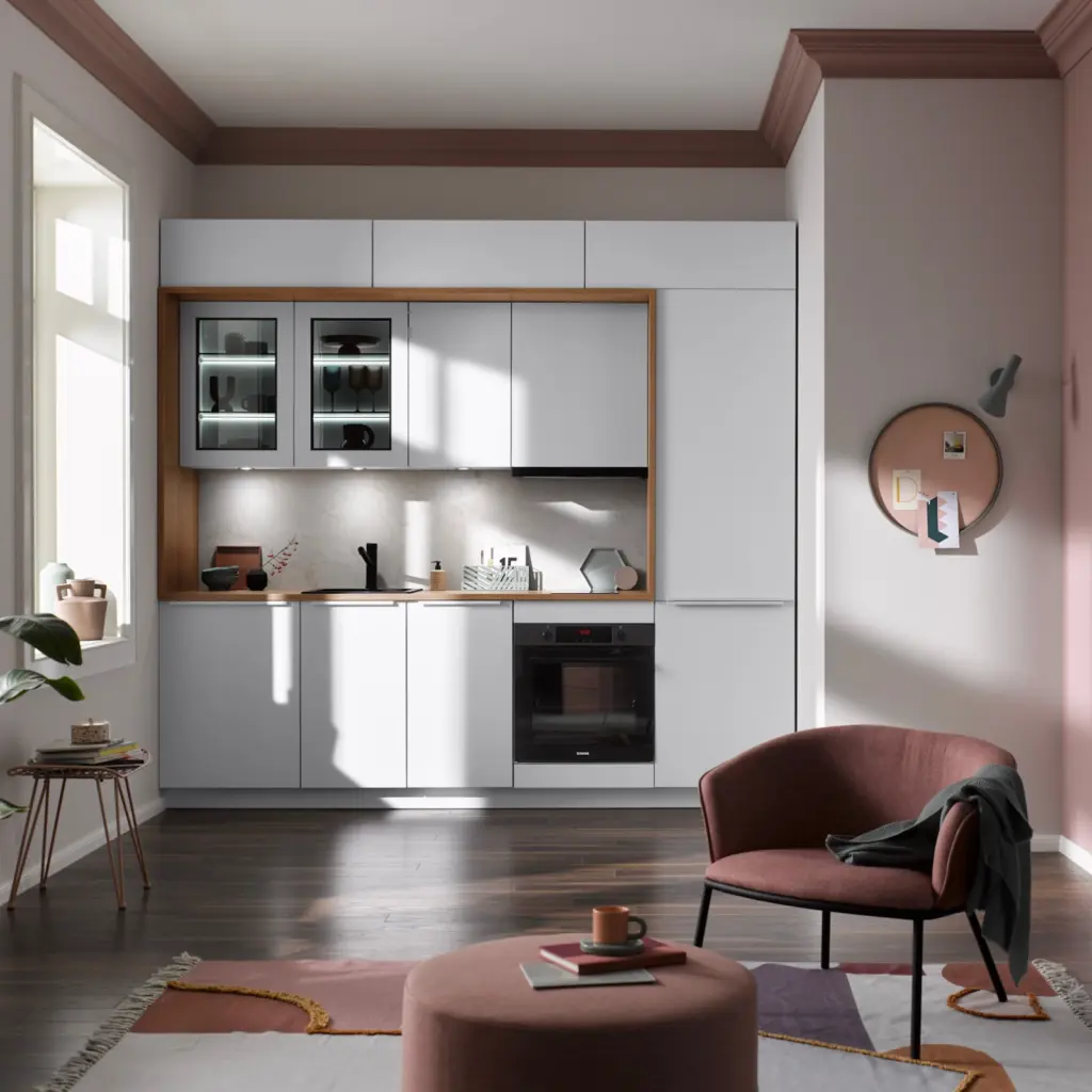 Petite cuisine linéaire blanche avec cadre en bois, évier noir et coin salon rose poudré assorti.