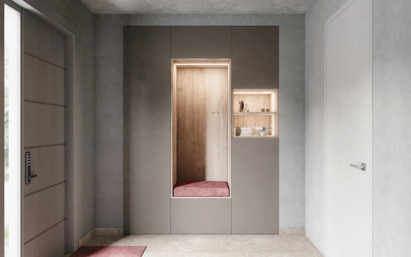 Aménagement d'une entrée moderne avec un grand meuble de rangement sur mesure encastré de couleur gris anthracite et bois clair, doté d'une alcôve rétroéclairée par LED avec banquette en velours rose et d'une petite niche décorative lumineuse.